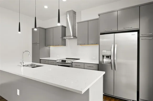 a kitchen with stainless steel appliances a refrigerator and a sink