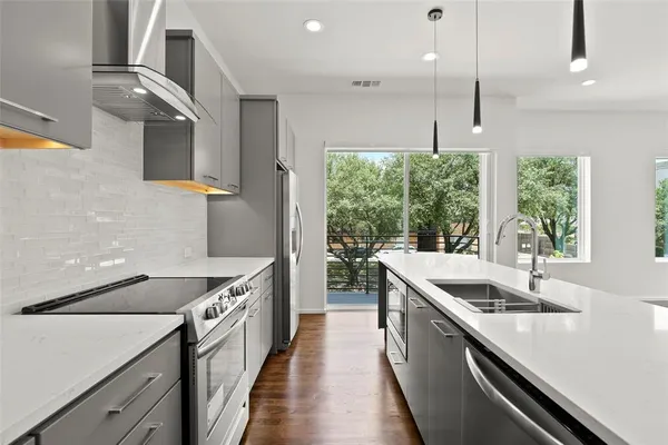 a kitchen with a sink and a large window