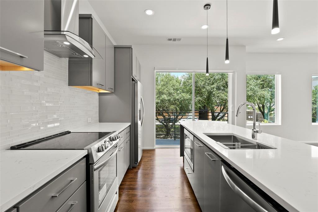 6250 Oram Street, Unit 102 Dallas, TX 75214 - Photo 9 of 21 a kitchen with a sink and a large window