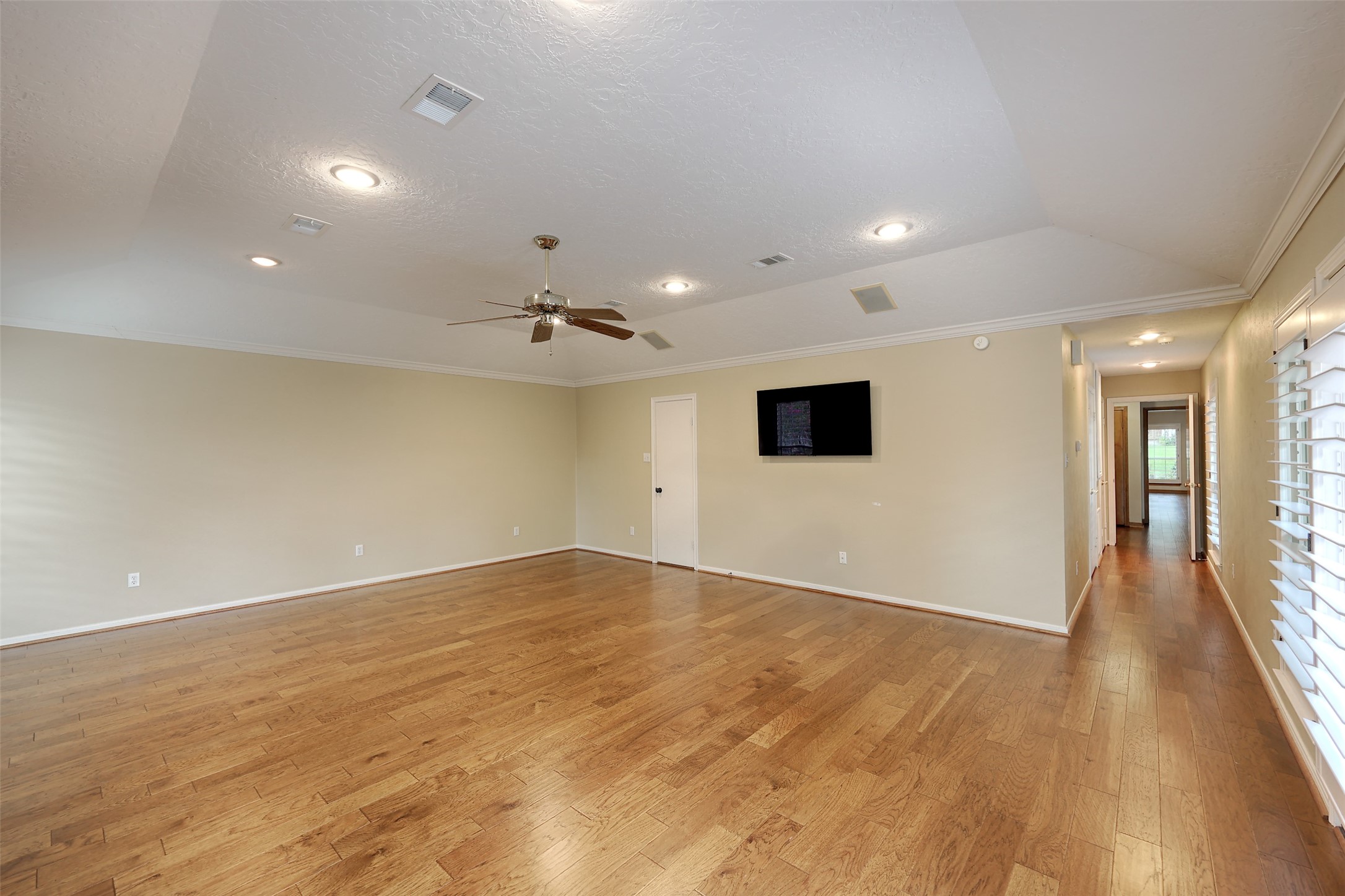 206 Virginia Lane Conroe, TX 77304 - Photo 20 of 36 an empty room with wooden floor and windows