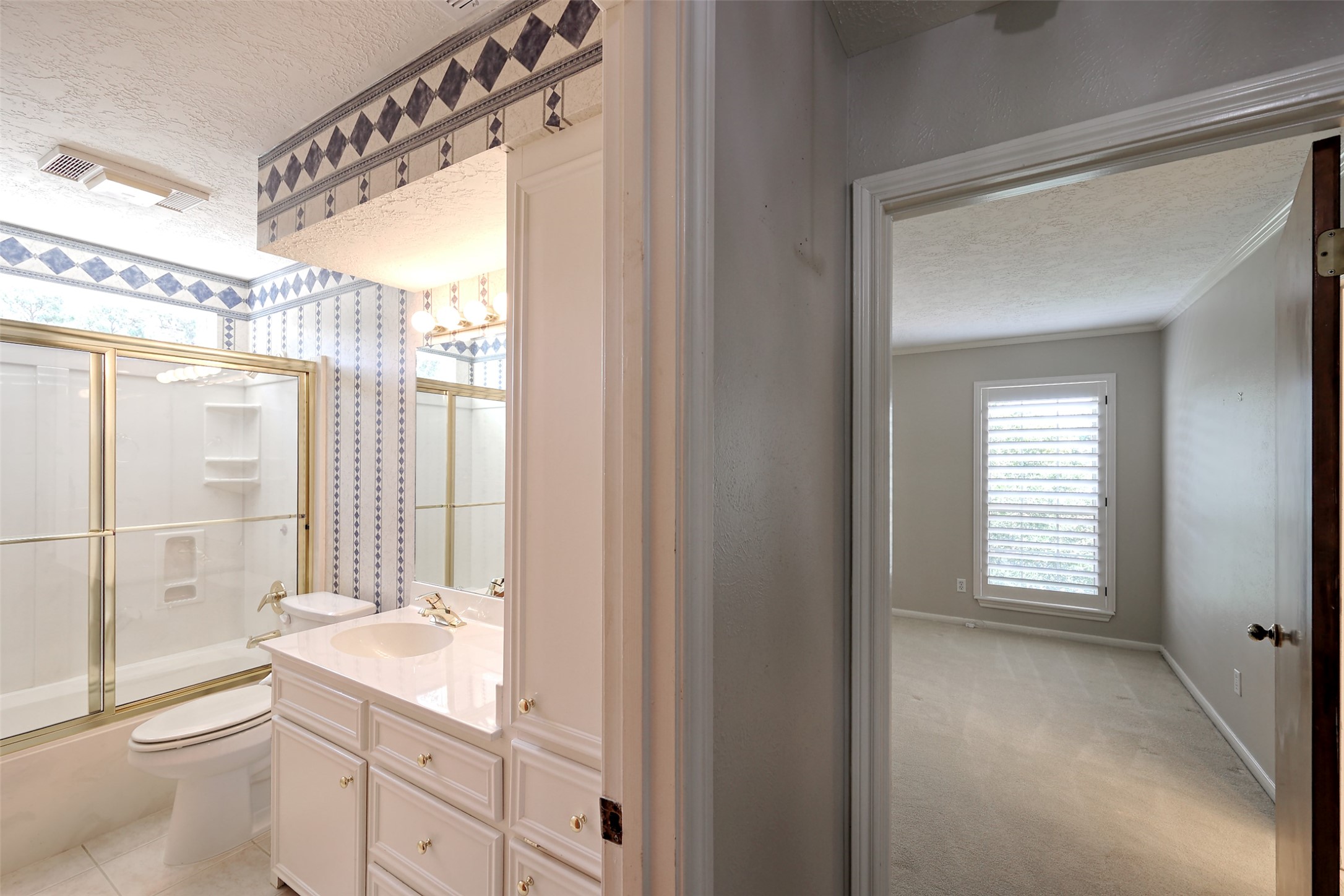 206 Virginia Lane Conroe, TX 77304 - Photo 26 of 36 a bathroom with a granite countertop sink a toilet and shower