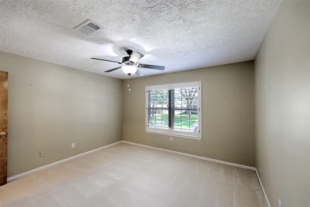 a view of a livingroom with a ceiling fan and window