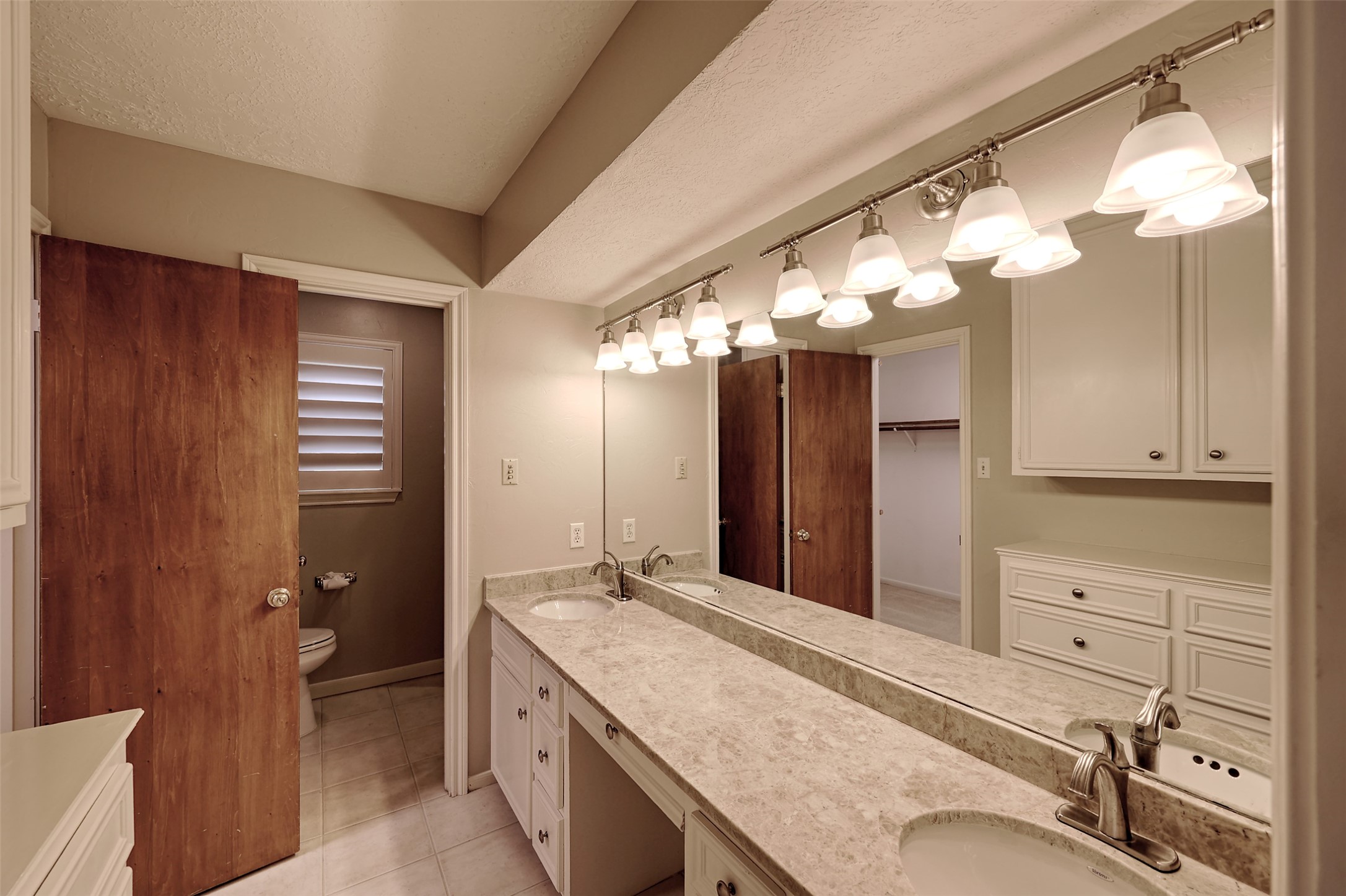 206 Virginia Lane Conroe, TX 77304 - Photo 29 of 36 a bathroom with a granite countertop sink mirror and a shower