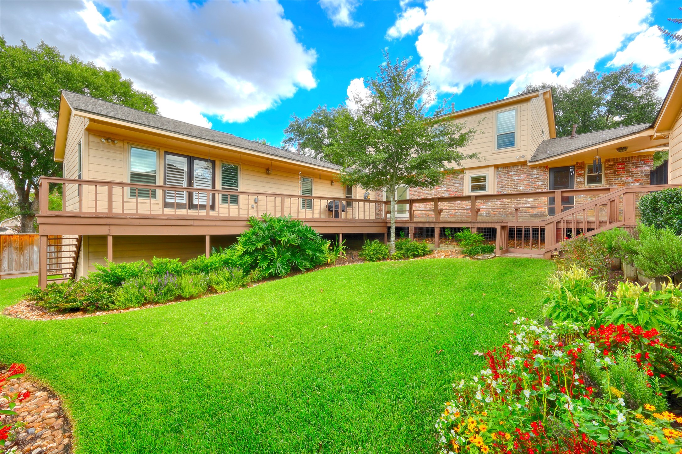 206 Virginia Lane Conroe, TX 77304 - Photo 30 of 36 a front view of a house with a garden and plants