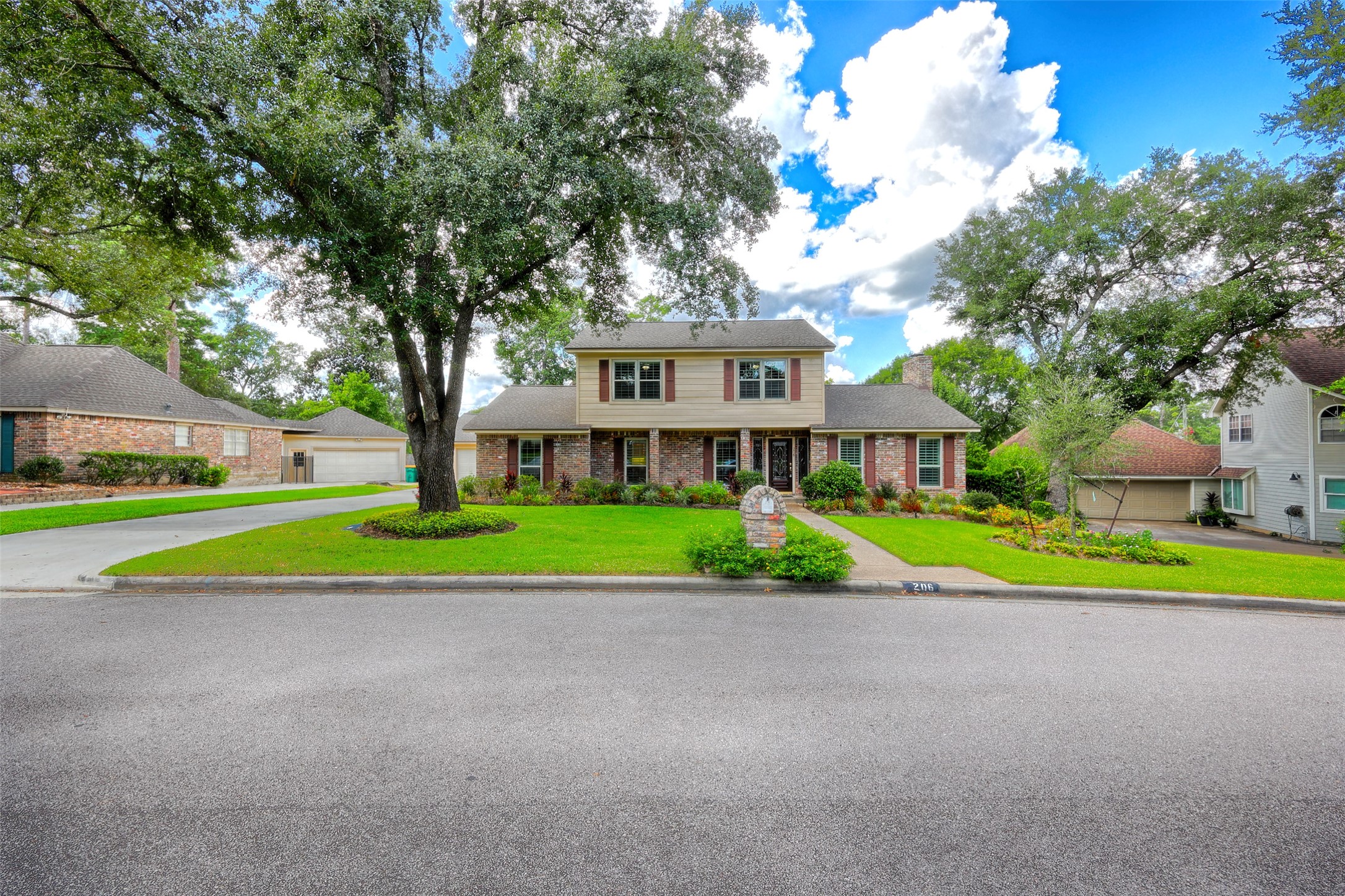 206 Virginia Lane Conroe, TX 77304 - Photo 3 of 36 a view of road with plants and large trees