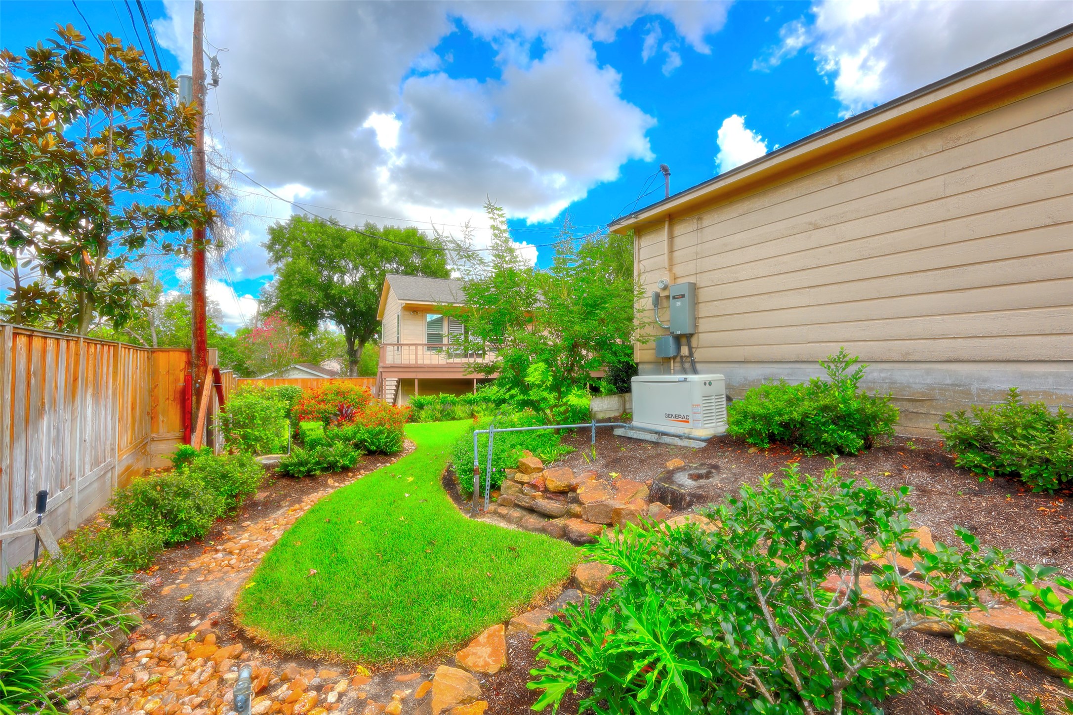 206 Virginia Lane Conroe, TX 77304 - Photo 34 of 36 a view of a garden with plants and a bench