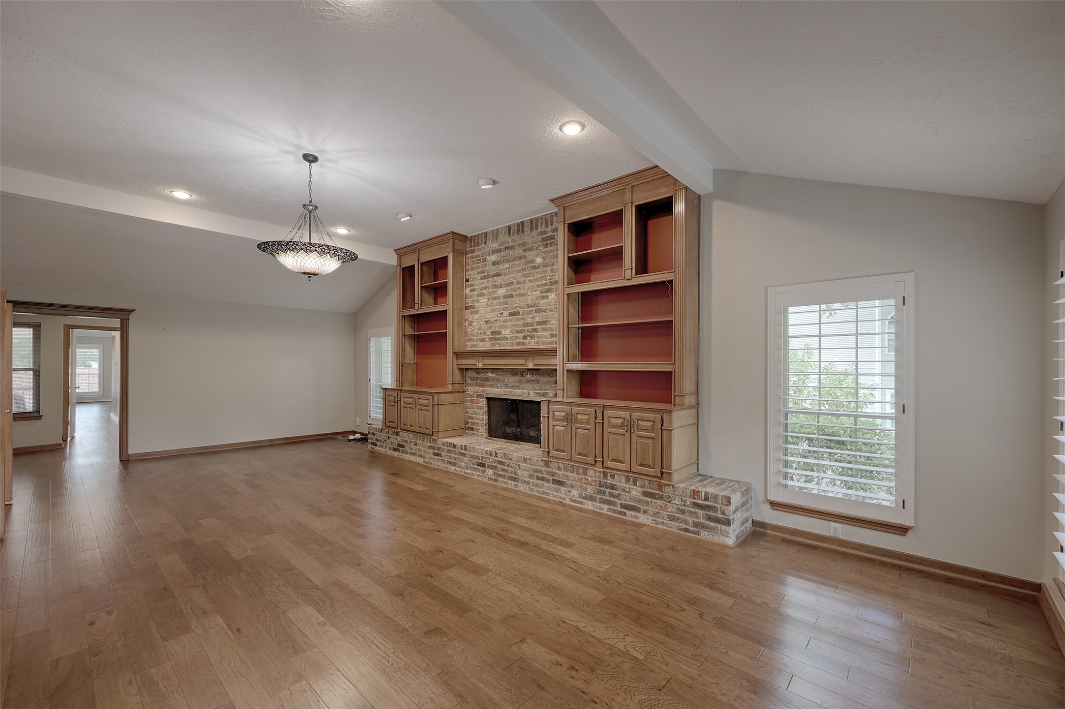 206 Virginia Lane Conroe, TX 77304 - Photo 8 of 36 an empty room with a fireplace and window