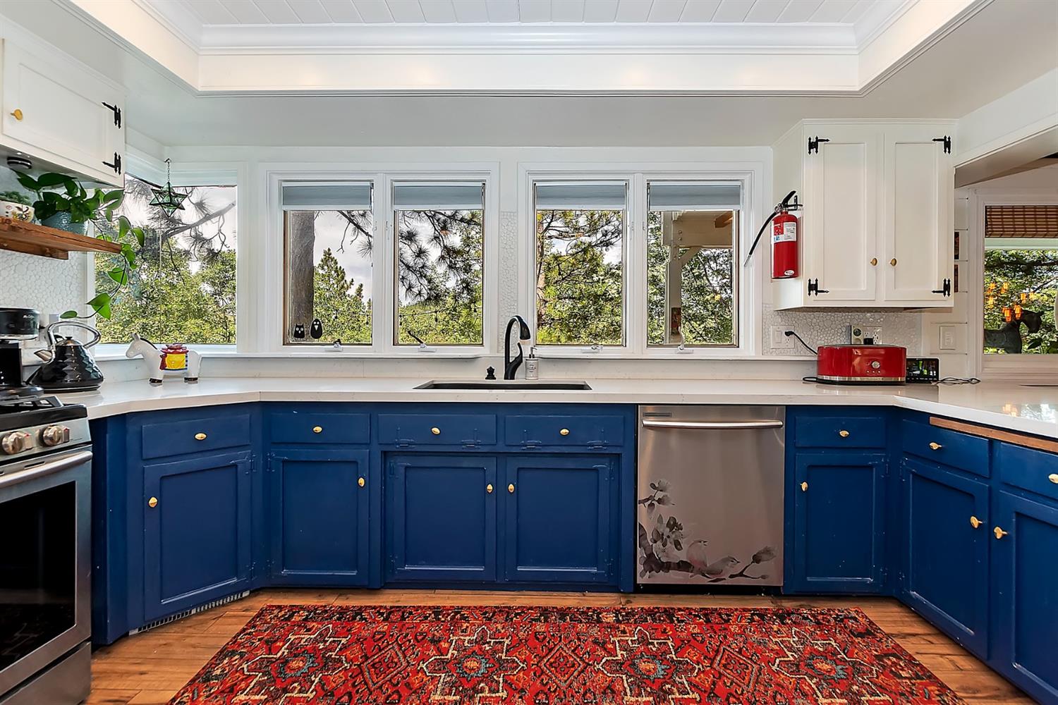 28277 Arbon Lane Lake Arrowhead, CA 92352 - Photo 11 of 50 a kitchen with stainless steel appliances granite countertop a sink dishwasher and wooden cabinets