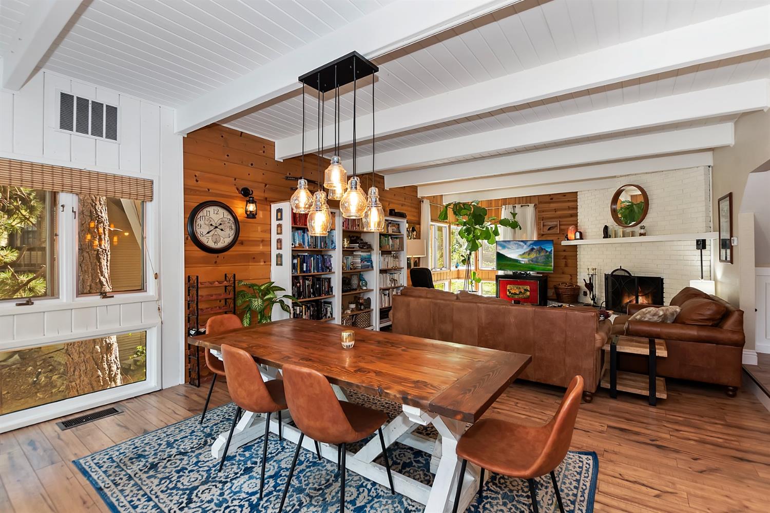 28277 Arbon Lane Lake Arrowhead, CA 92352 - Photo 16 of 50 a dining room with furniture a fireplace and wooden floor