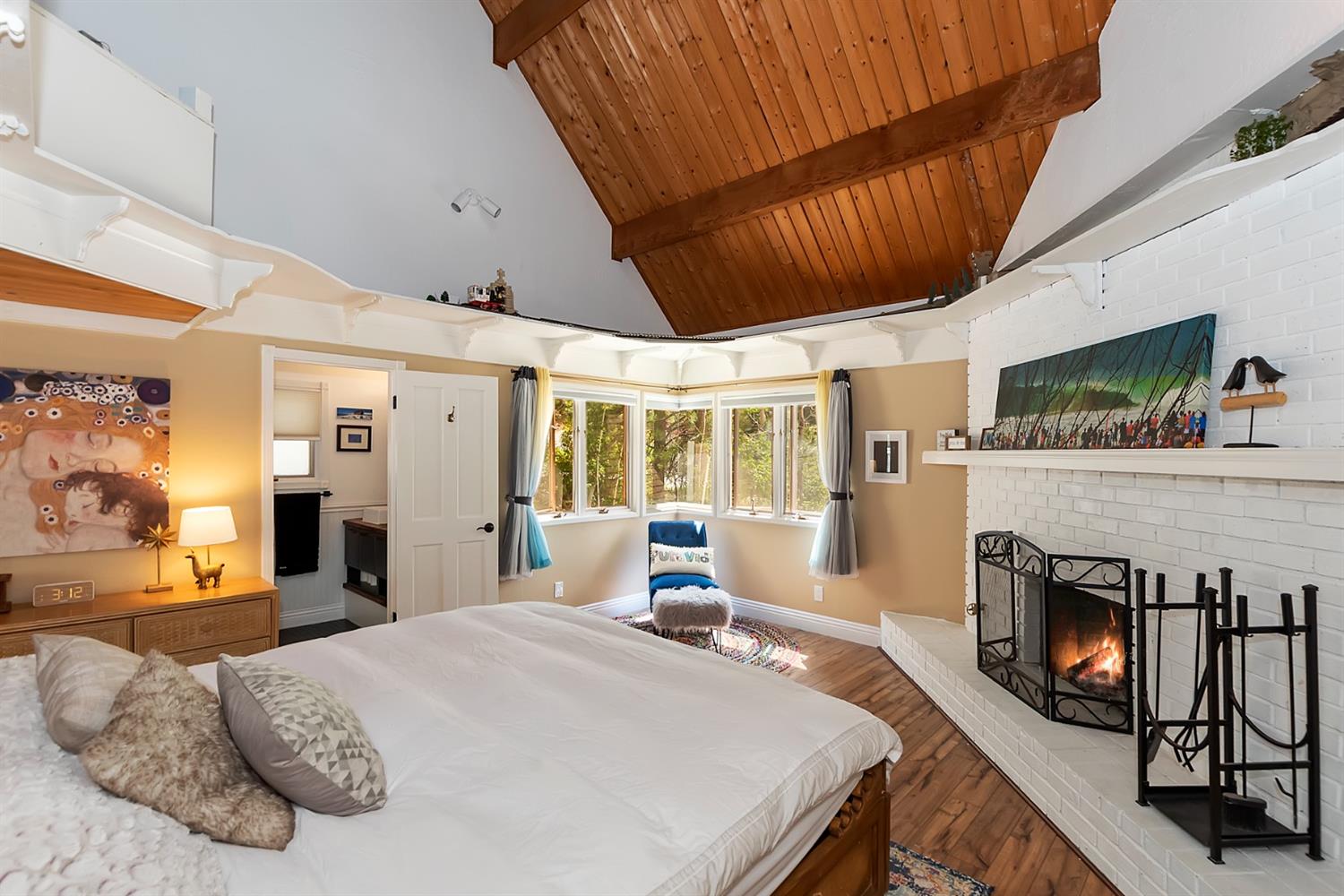 28277 Arbon Lane Lake Arrowhead, CA 92352 - Photo 21 of 50 a bed room with furniture and a fireplace