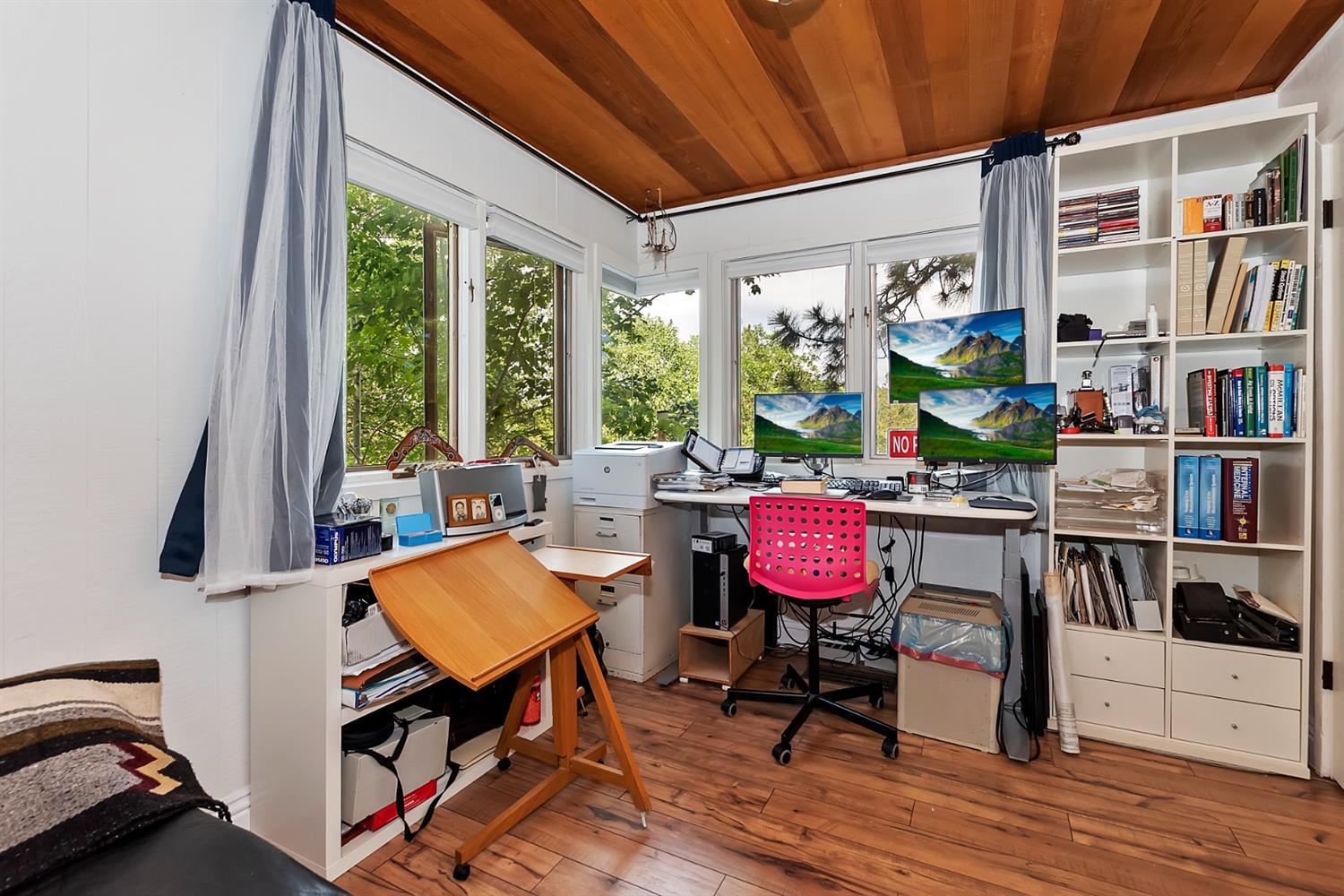 28277 Arbon Lane Lake Arrowhead, CA 92352 - Photo 41 of 50 a living room with furniture a bookshelf and a window