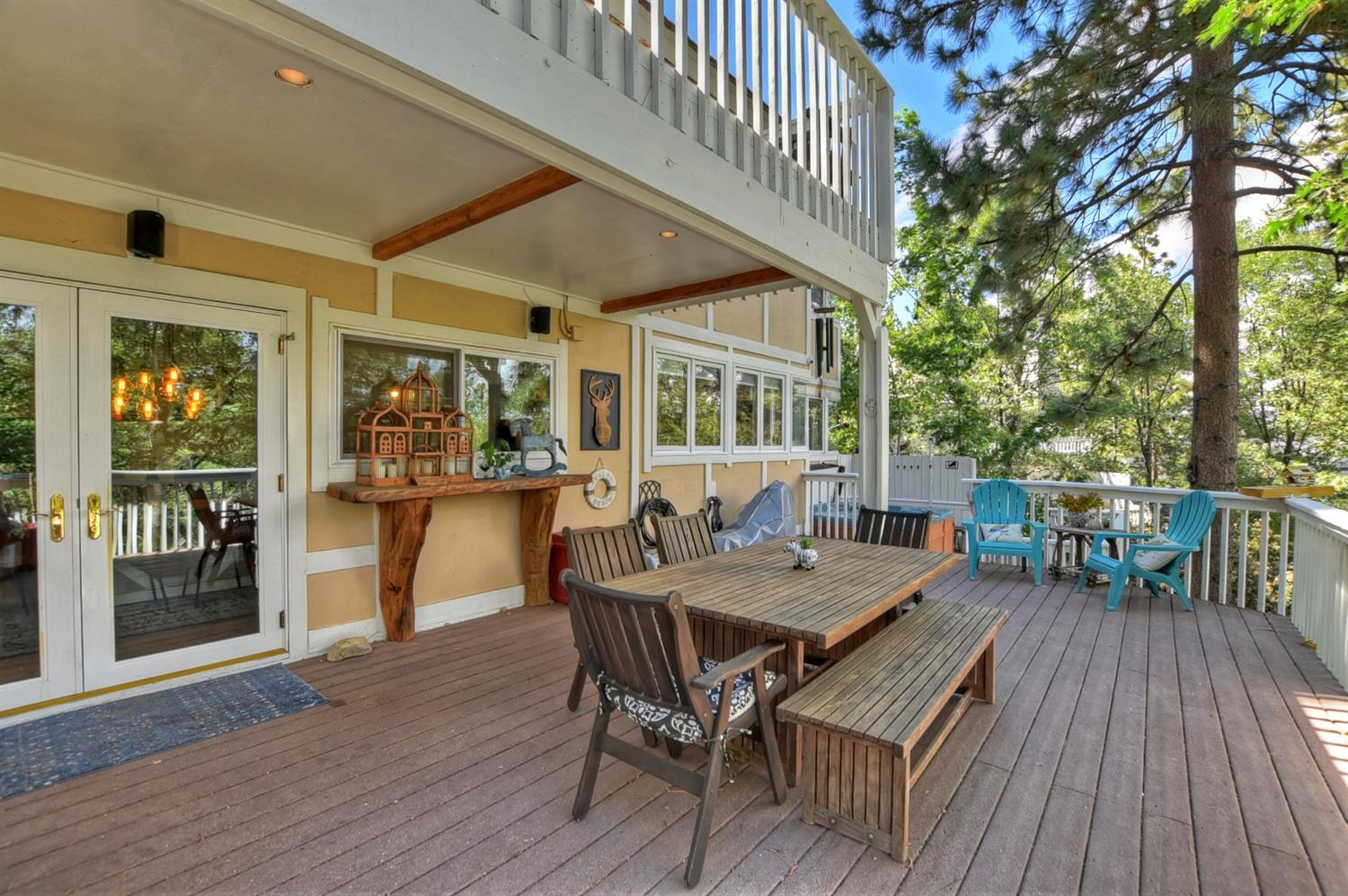 28277 Arbon Lane Lake Arrowhead, CA 92352 - Photo 45 of 50 a view of a patio with table and chairs and floor to ceiling window with wooden floor