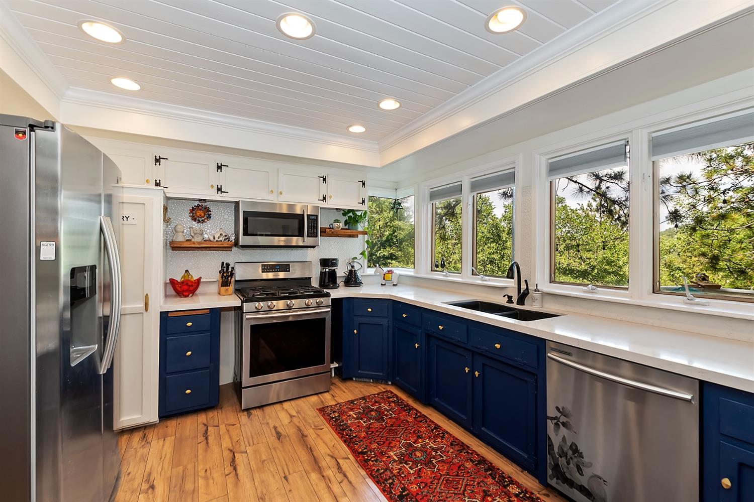 28277 Arbon Lane Lake Arrowhead, CA 92352 - Photo 8 of 50 a kitchen with stainless steel appliances granite countertop a sink stove and refrigerator