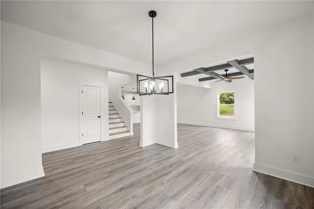 a view of a kitchen with wooden floor and a ceiling fan