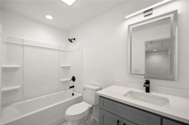 an empty room with a window and a ceiling fan