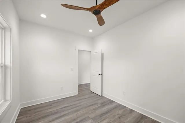 a view of a room with wooden floor
