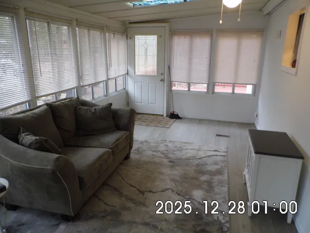 a view of a livingroom with furniture and staircase