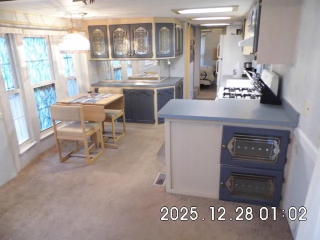 a kitchen with stainless steel appliances granite countertop a stove and a refrigerator