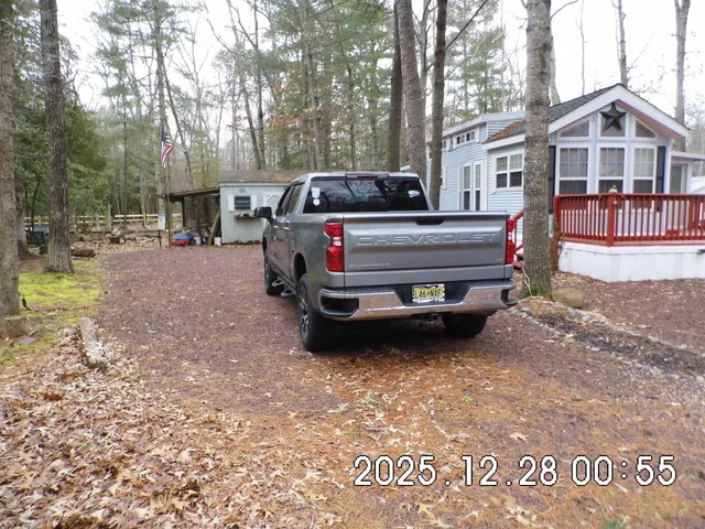 a front view of a house with a yard fountain and a fire pit