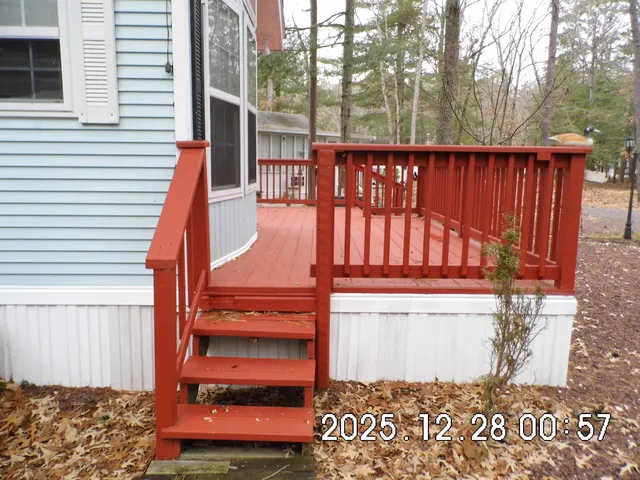 a view of a house with a yard and wooden fence