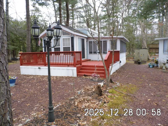 a view of house with backyard and deck
