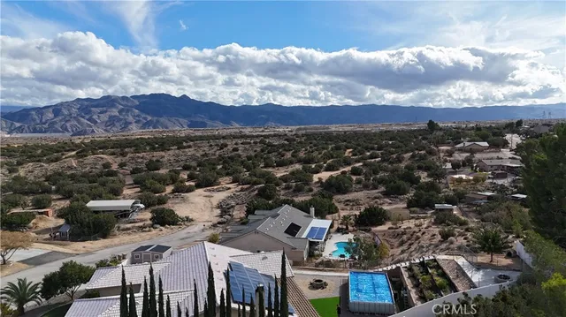 a room with water heater and wooden cabinets