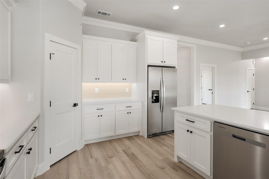 505 Limestone Circle Mabank, TX 75147 - Photo 11 of 37 a kitchen with white cabinets and refrigerator
