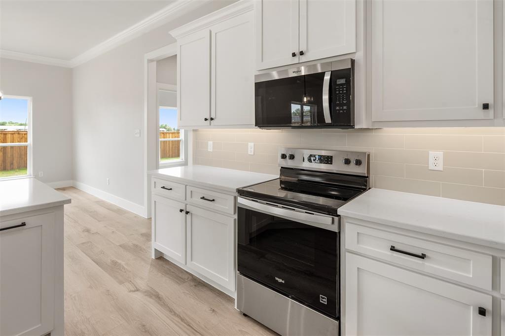 505 Limestone Circle Mabank, TX 75147 - Photo 15 of 37 a kitchen with stainless steel appliances white cabinets and a stove a oven with white countertops