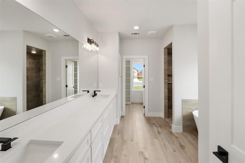 505 Limestone Circle Mabank, TX 75147 - Photo 19 of 37 a spacious bedroom with a bed and a large mirror