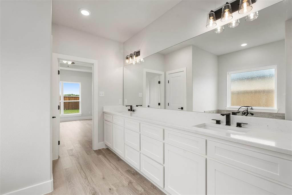 505 Limestone Circle Mabank, TX 75147 - Photo 22 of 37 a bathroom with double vanity and a mirror
