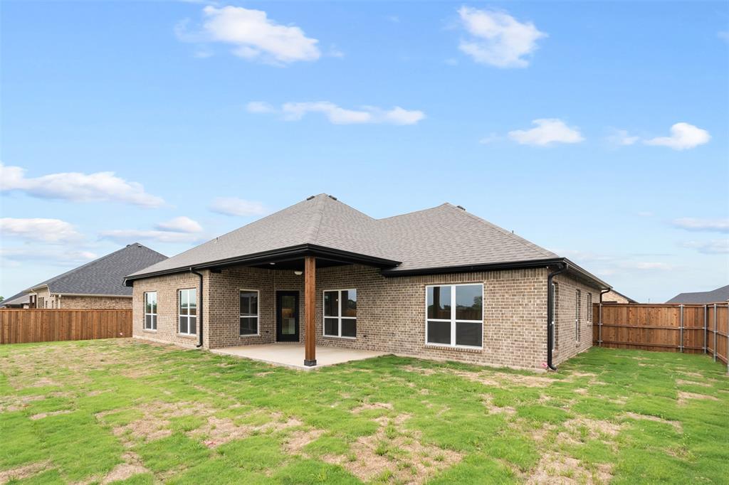 505 Limestone Circle Mabank, TX 75147 - Photo 32 of 37 a front view of a house with a garden and yard