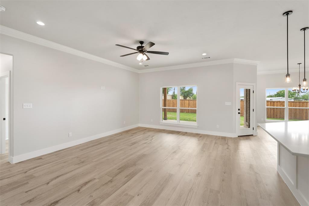 505 Limestone Circle Mabank, TX 75147 - Photo 4 of 37 a view of an empty room with a window and wooden floor