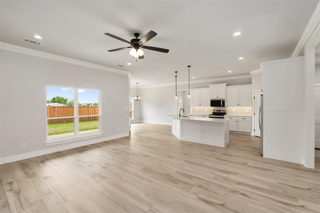505 Limestone Circle Mabank, TX 75147 - Photo 5 of 37 a view of kitchen with kitchen island stainless steel appliances wooden floor and window