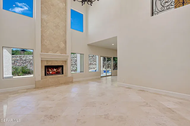 an empty room with stairs and wooden floor