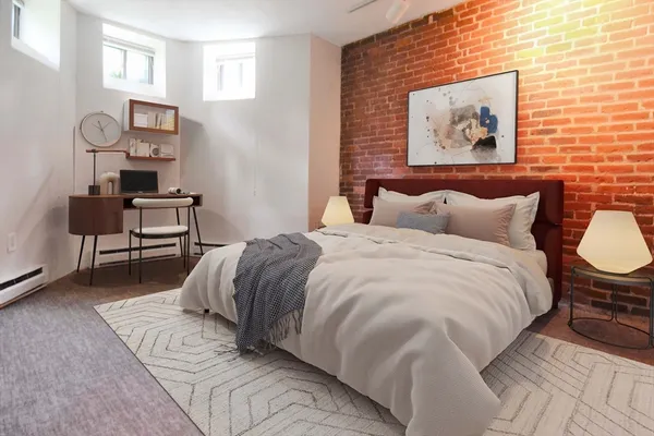 a bedroom with a bed and painting on the wall