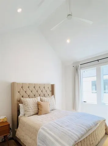 a bedroom with a bed and a window