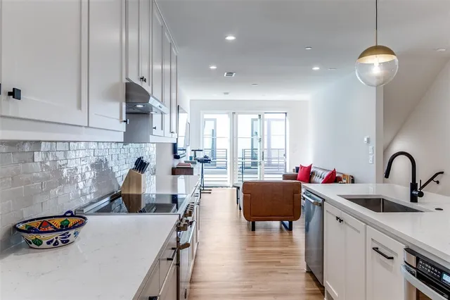 a kitchen with cabinets a sink and appliances