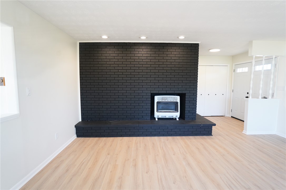 8746 Grubbs-Rex Road Arcanum, OH 45304 - Photo 22 of 38 This inviting space features a charming fireplace with light wood floors and recessed lighting.