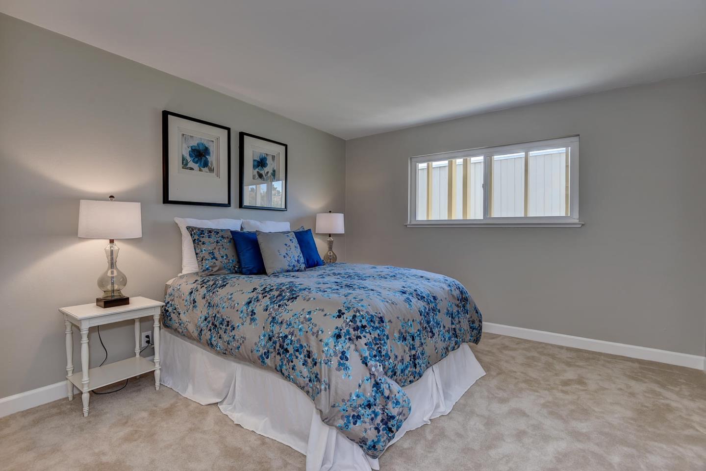 836 Pomeroy Avenue, Unit 70 Santa Clara, CA 95051 - Photo 11 of 17 a bedroom with a bed and a lamp on dresser