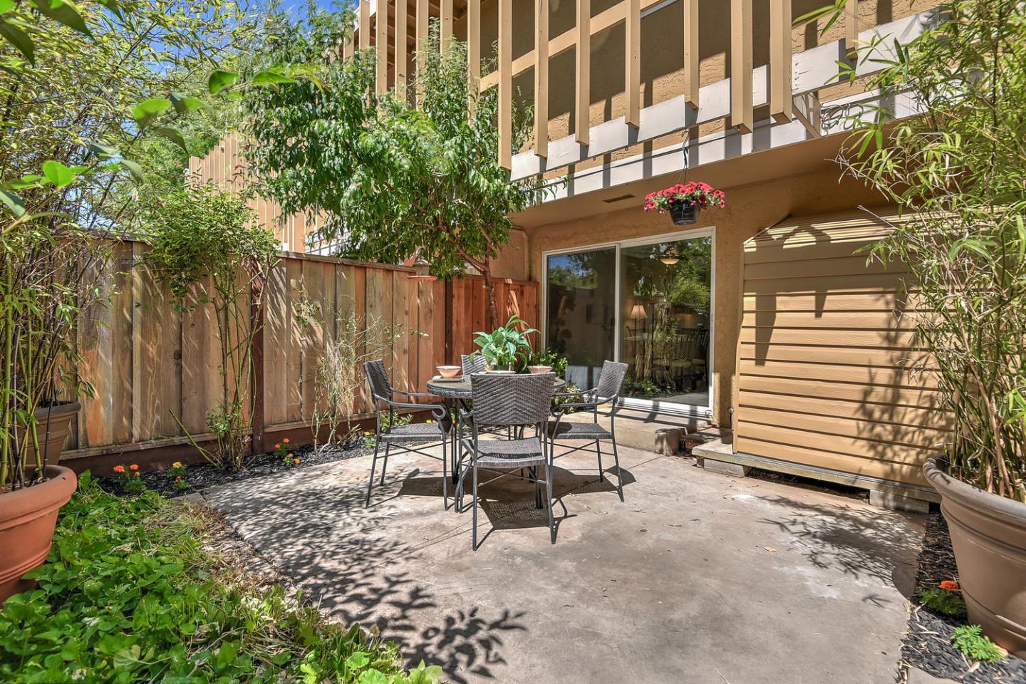 836 Pomeroy Avenue, Unit 70 Santa Clara, CA 95051 - Photo 15 of 17 a view of a patio with a table and chairs