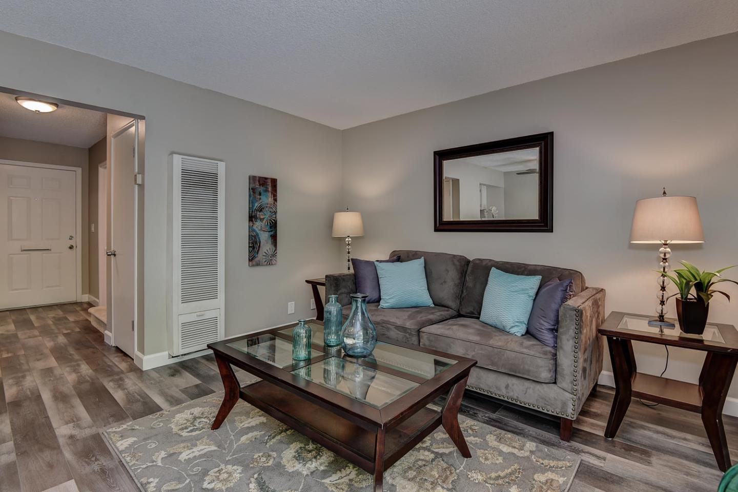 836 Pomeroy Avenue, Unit 70 Santa Clara, CA 95051 - Photo 2 of 17 a living room with furniture and wooden floor