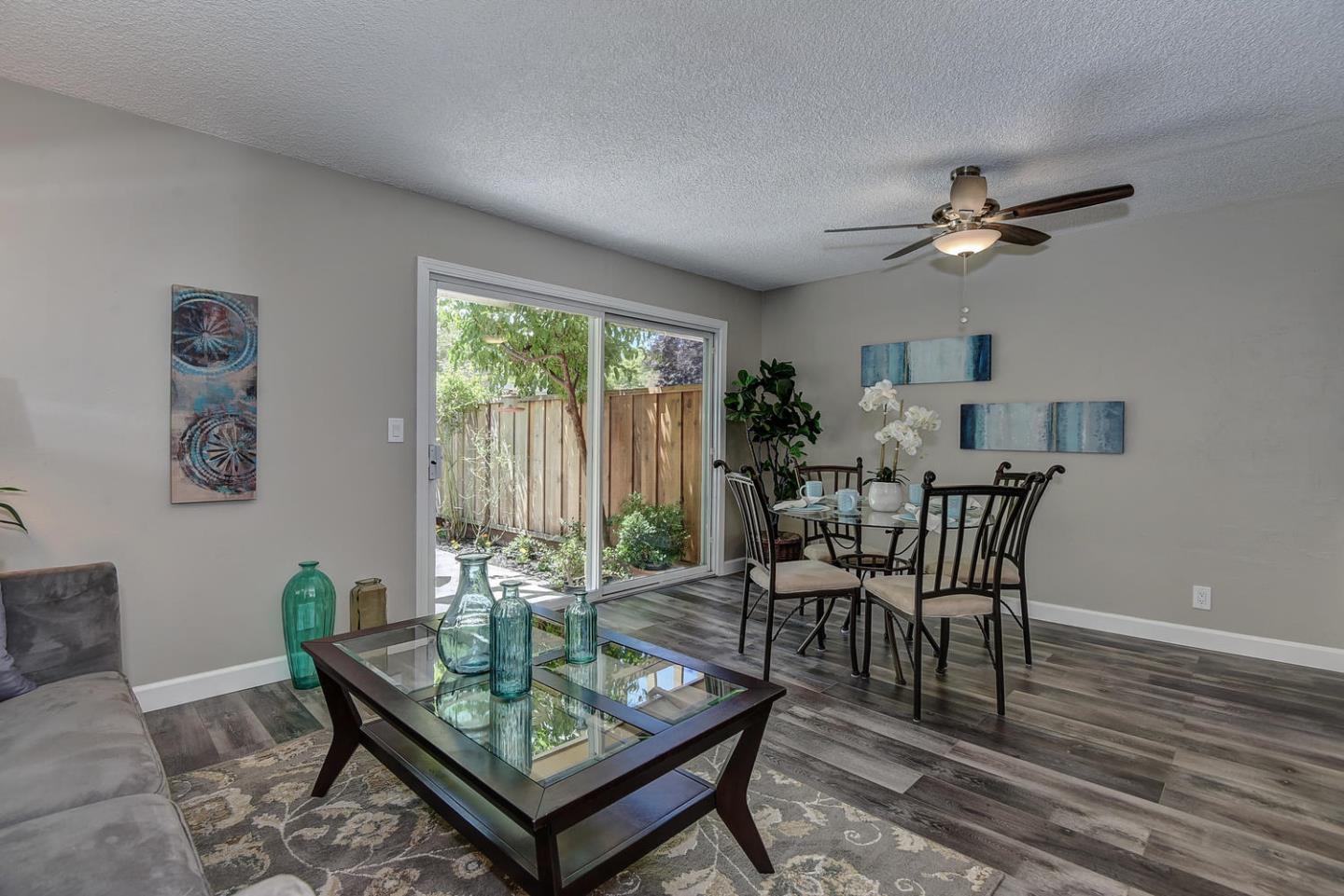 836 Pomeroy Avenue, Unit 70 Santa Clara, CA 95051 - Photo 3 of 17 a dining room with furniture a rug and a chandelier