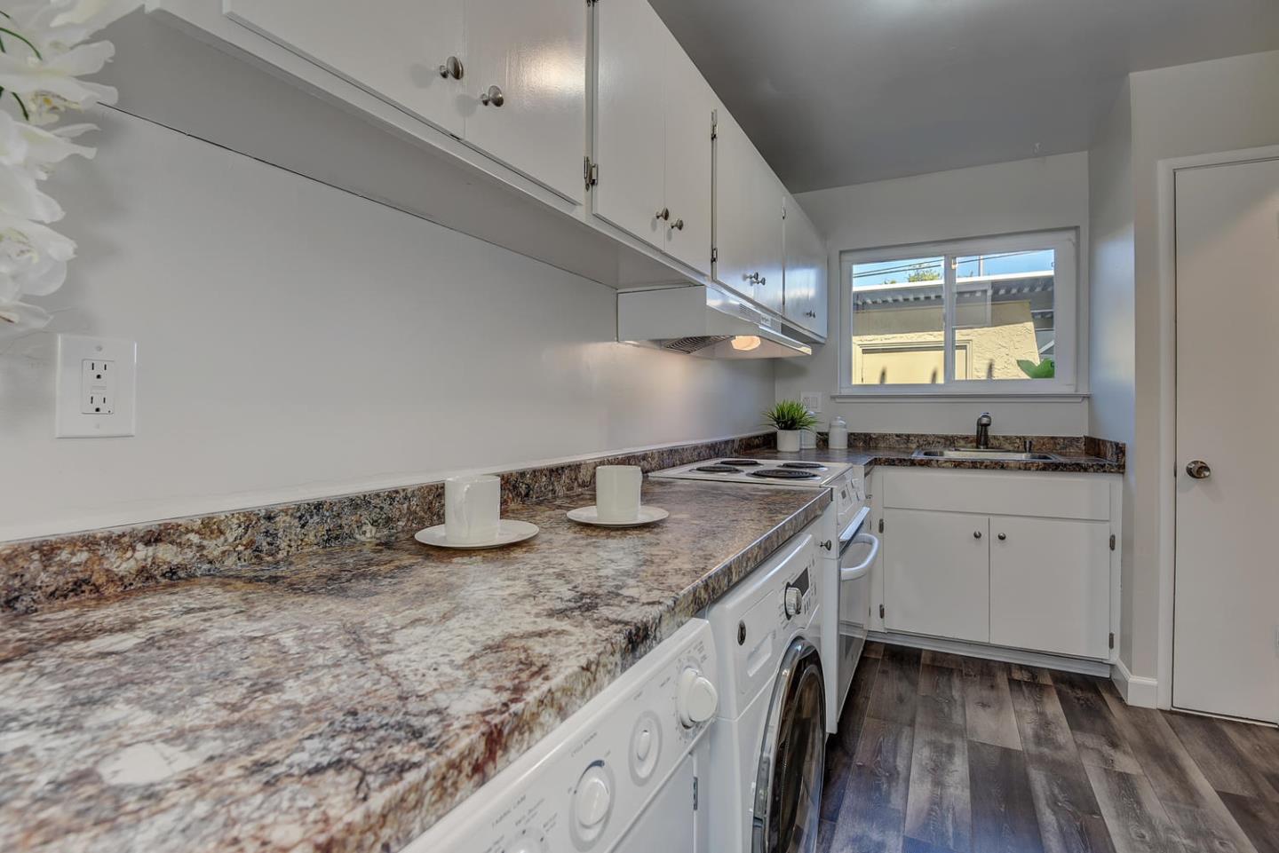 836 Pomeroy Avenue, Unit 70 Santa Clara, CA 95051 - Photo 7 of 17 a kitchen with granite countertop a sink and a stove
