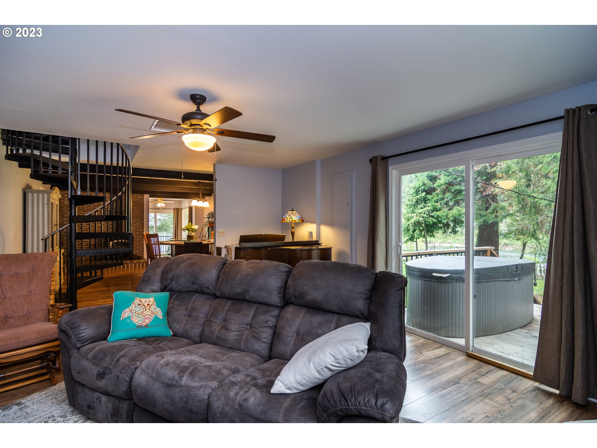 11533 Tyee Road Umpqua, OR 97486 - Photo 13 of 45 a living room with furniture a chandelier and a large window