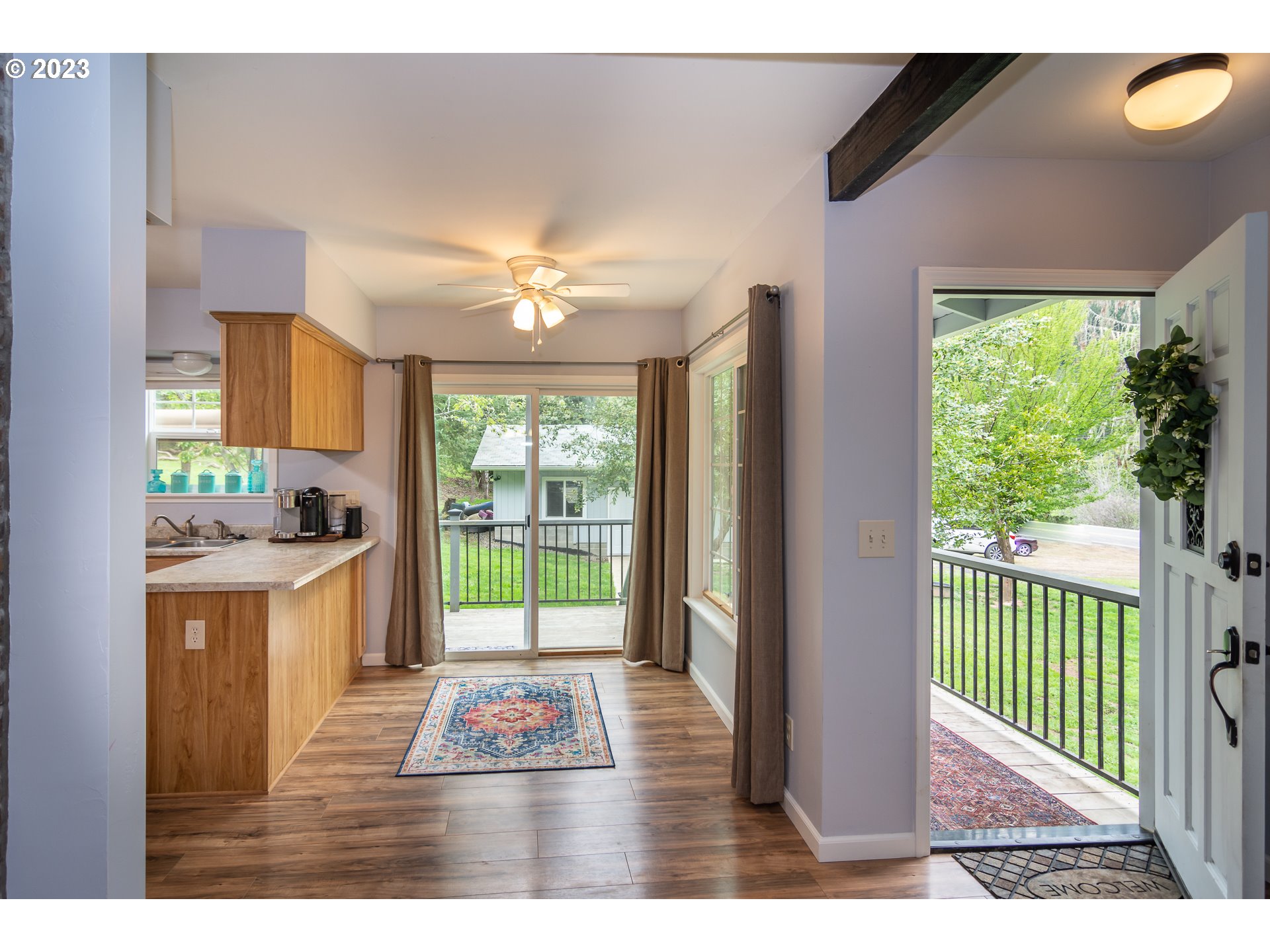 11533 Tyee Road Umpqua, OR 97486 - Photo 16 of 45 a open kitchen with granite countertop a stove top oven a sink with wooden floors