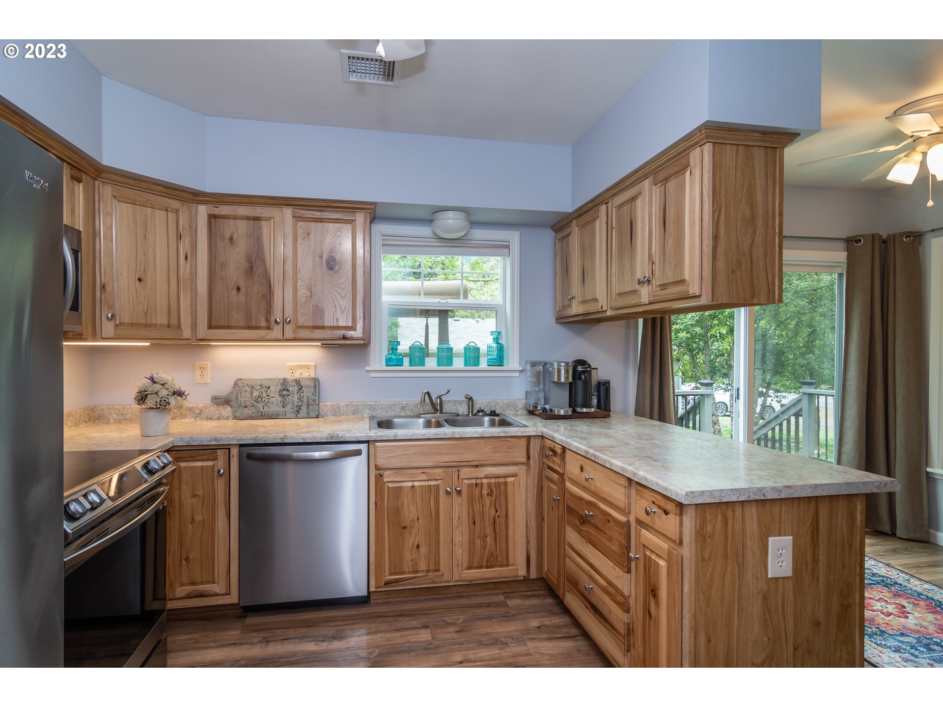 11533 Tyee Road Umpqua, OR 97486 - Photo 20 of 45 a kitchen with kitchen island granite countertop a sink stove and cabinets