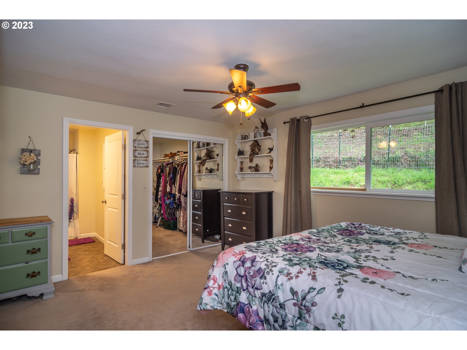 11533 Tyee Road Umpqua, OR 97486 - Photo 24 of 45 a bedroom with a bed and a chandelier