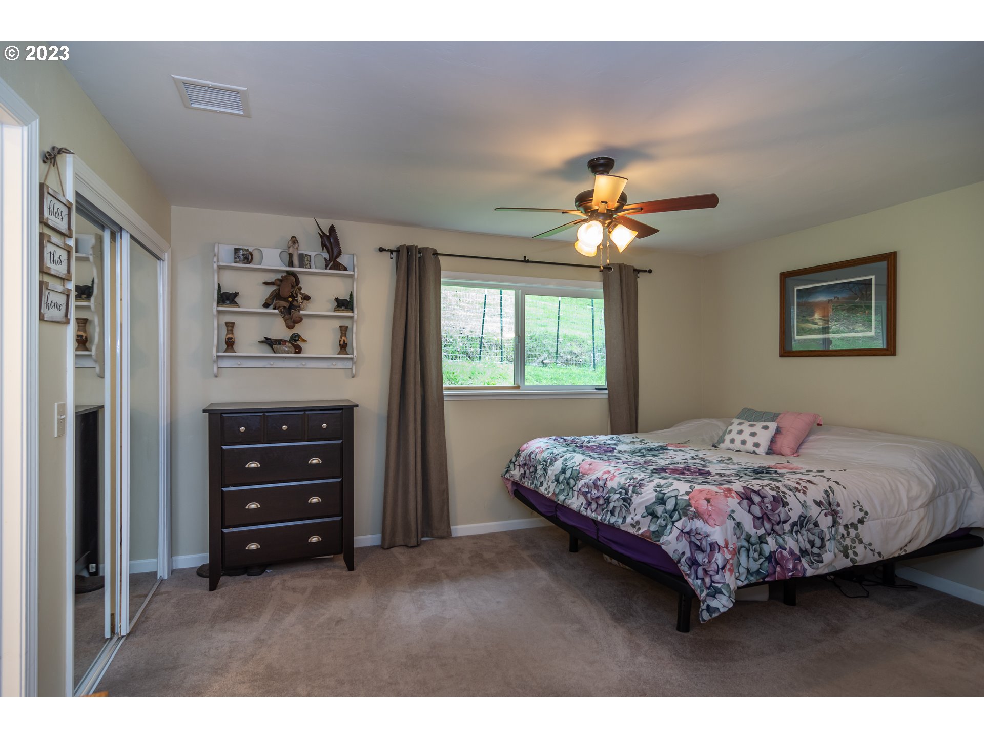 11533 Tyee Road Umpqua, OR 97486 - Photo 30 of 45 a bedroom with a bed a window and closet