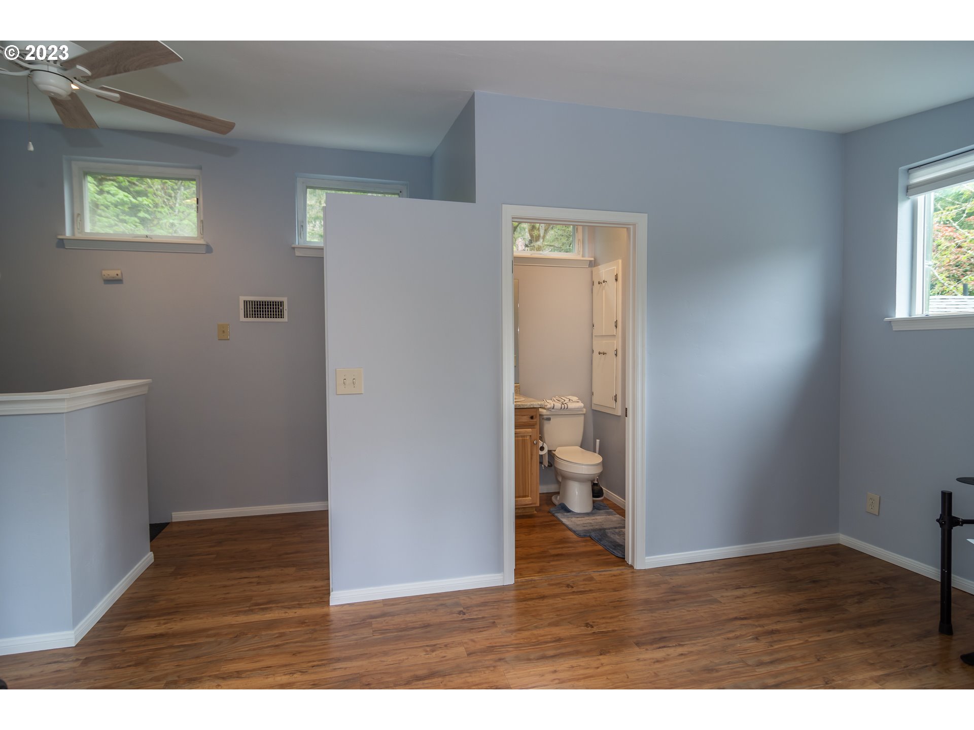 11533 Tyee Road Umpqua, OR 97486 - Photo 34 of 45 a view of an empty room with wooden floor and a window