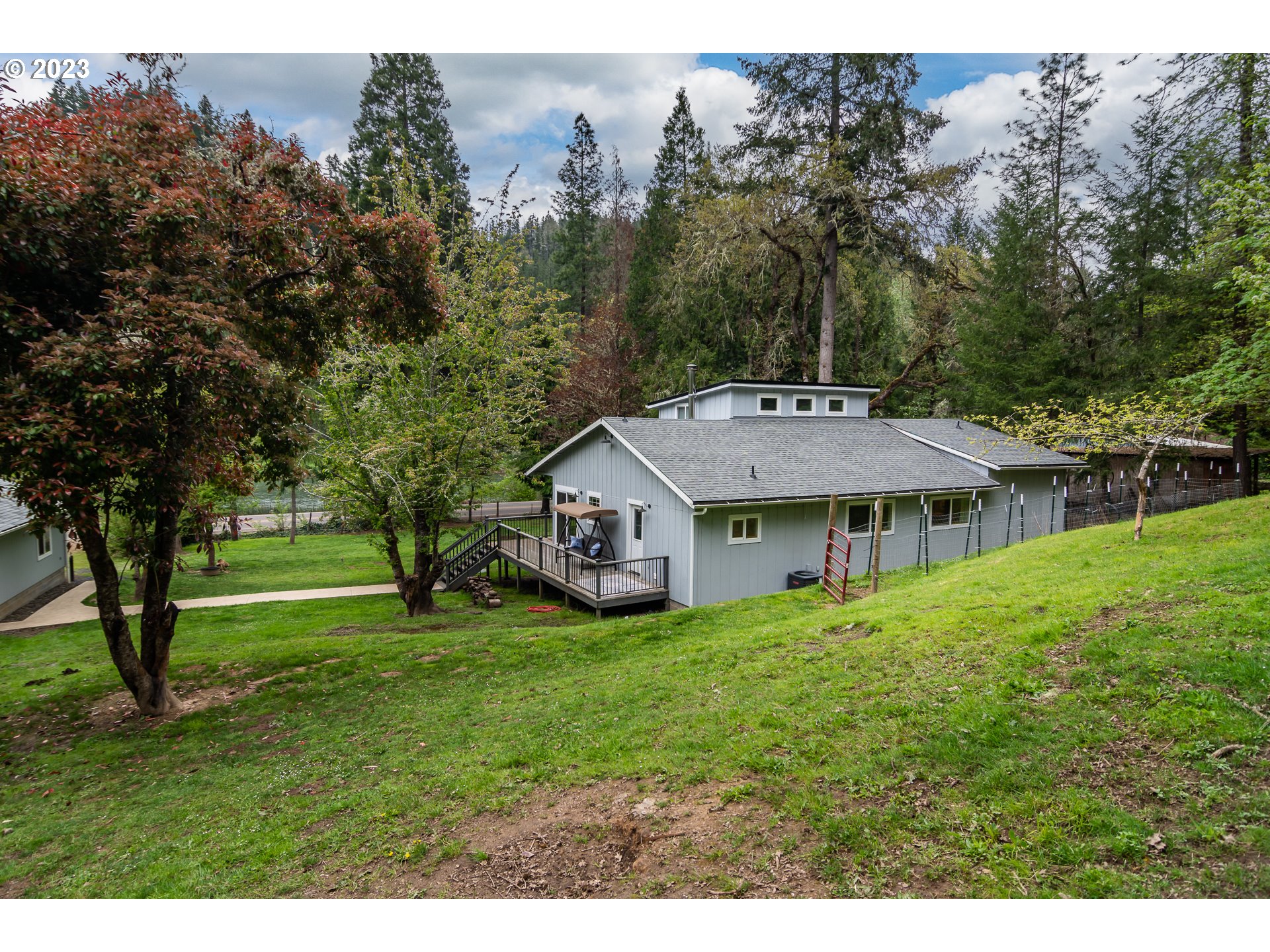 11533 Tyee Road Umpqua, OR 97486 - Photo 6 of 45 a backyard of a house with table and chairs